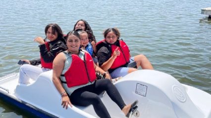 Visitors enjoy riding on a paddle boat on the lake at Prado Regional Park.