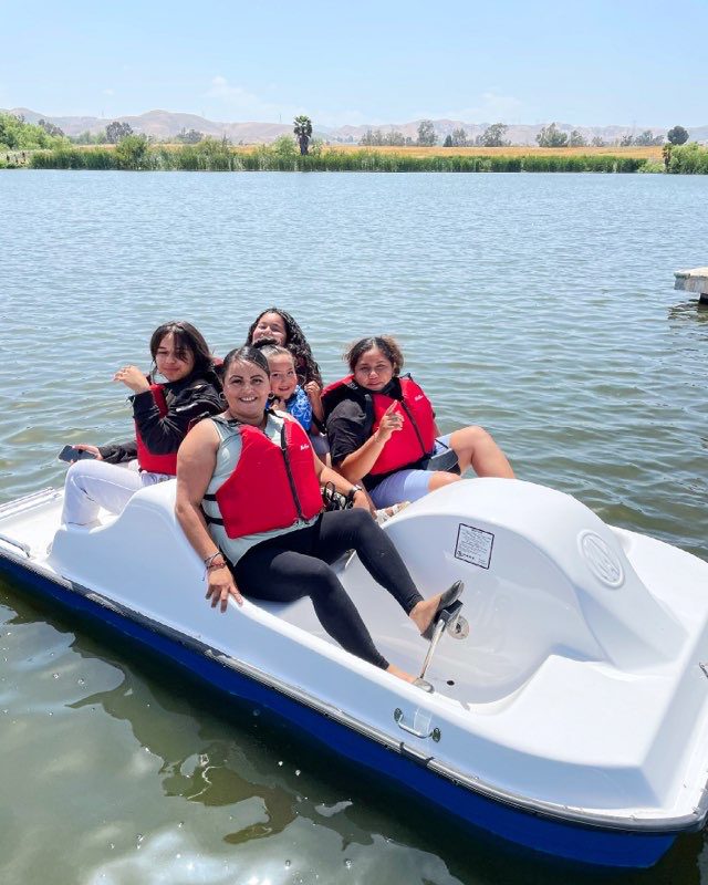 Visitors enjoy riding on a paddle boat on the lake at Prado Regional Park.