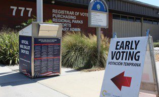 An Early Voting sign points to the Early Voting location at San Bernardino County Registrar of Voters Office.