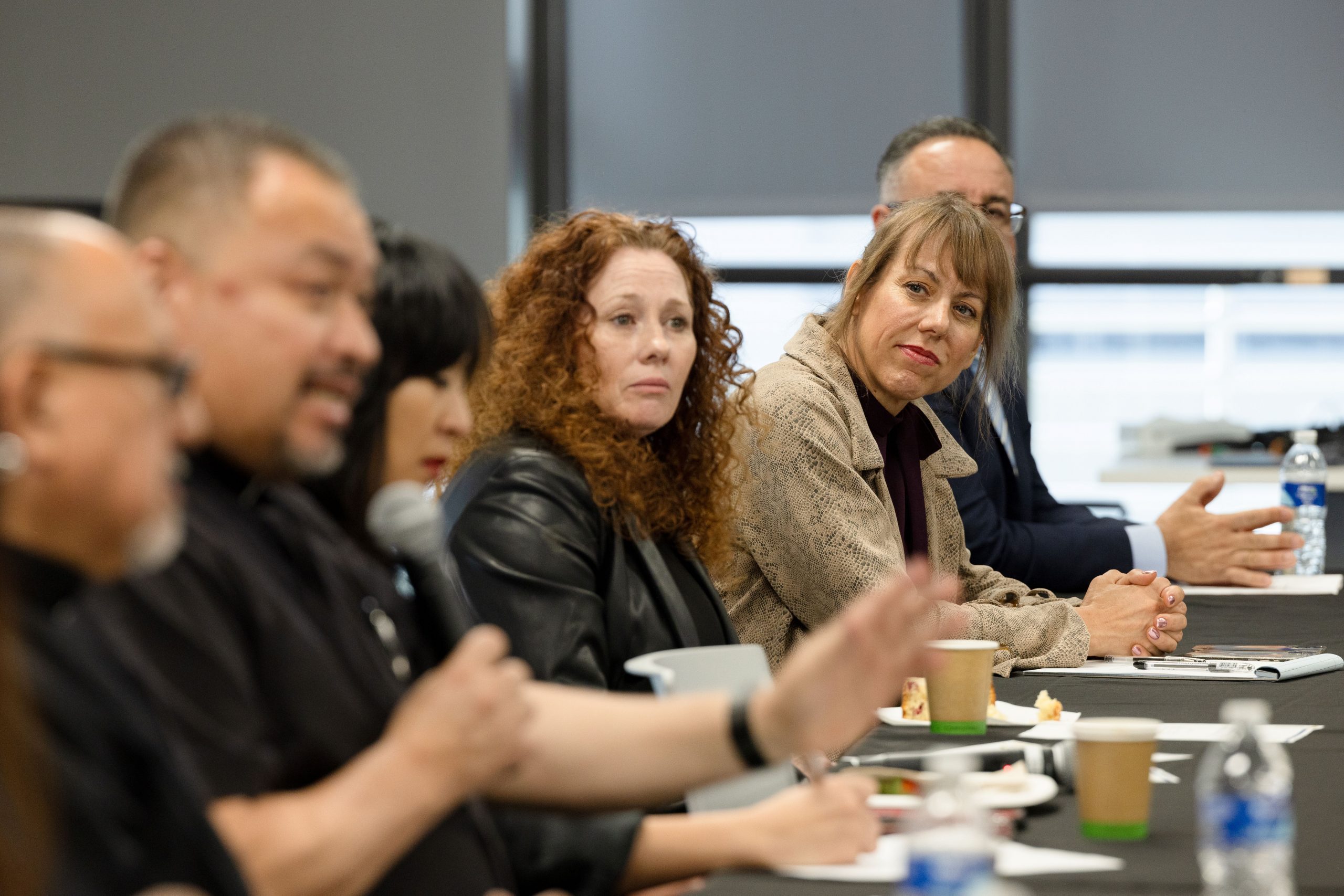 Rev. Rogelio Gonzalez of Our Lady of the Assumption Church speaks from his seat as AEO Diane Rundles, CDH Director Carrie Harmon, OHS Chief Marcus Dillard, Mayor Helen Tran, and other attendees at the homelessness roundtable listen.