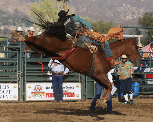 A person riding a horse during a rodeo event.