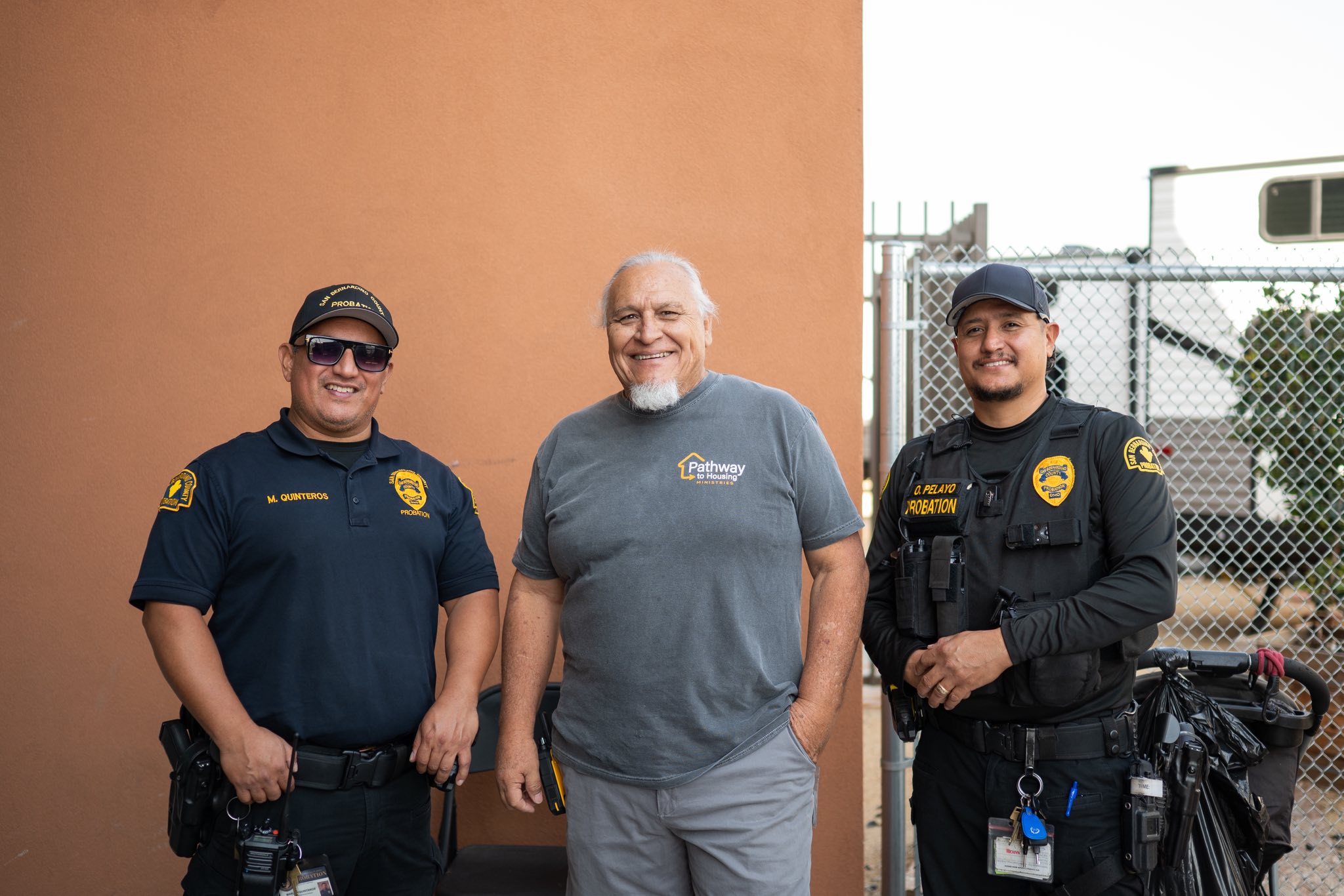 Probation officers and community partner pose together during outreach focused on housing support.