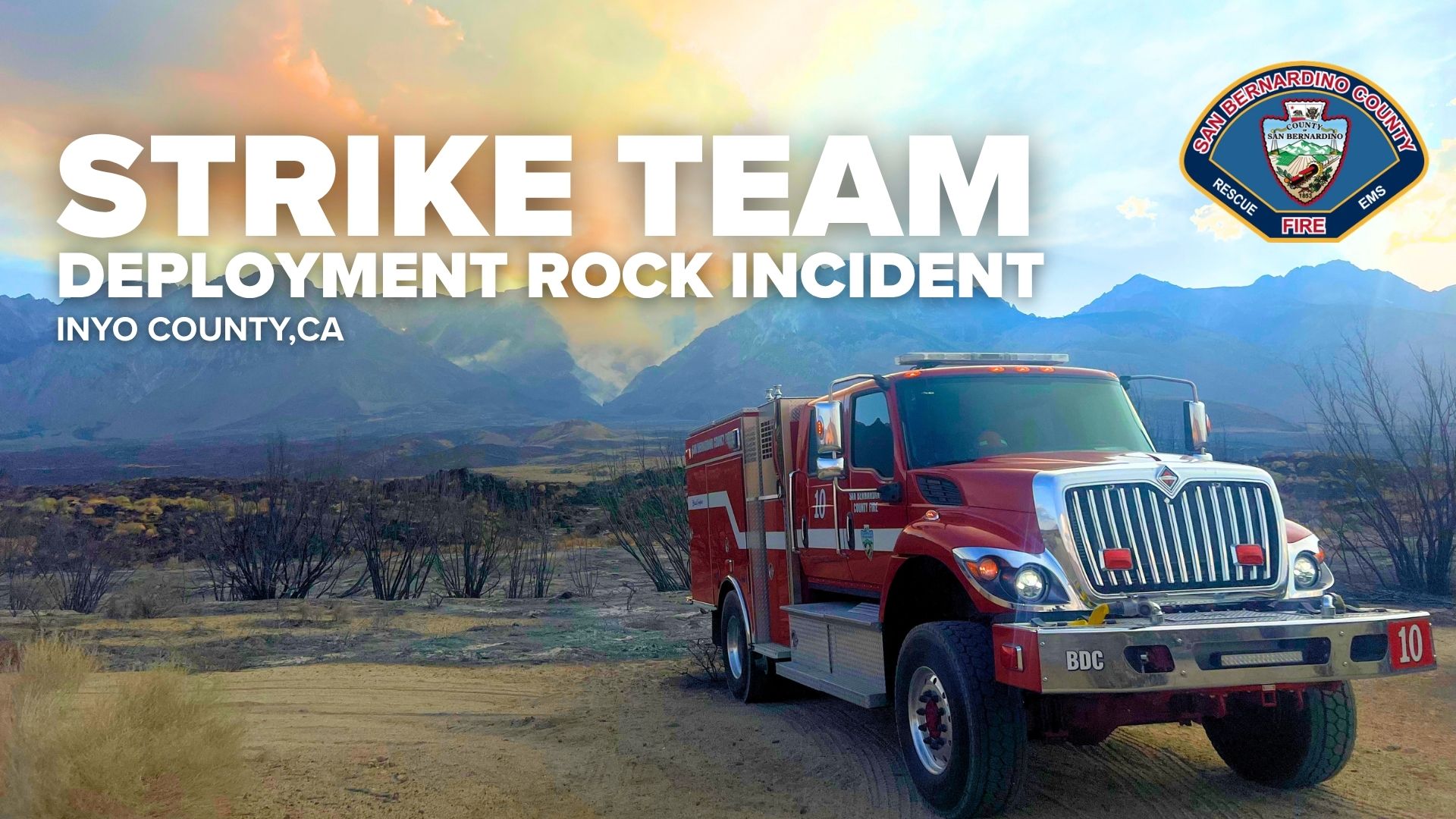 Parked fire truck on a dirt road with mountains in the background. Text reads "Strike Team Deployment Rock Incident, Inyo County, CA." County Fire logo also visible.