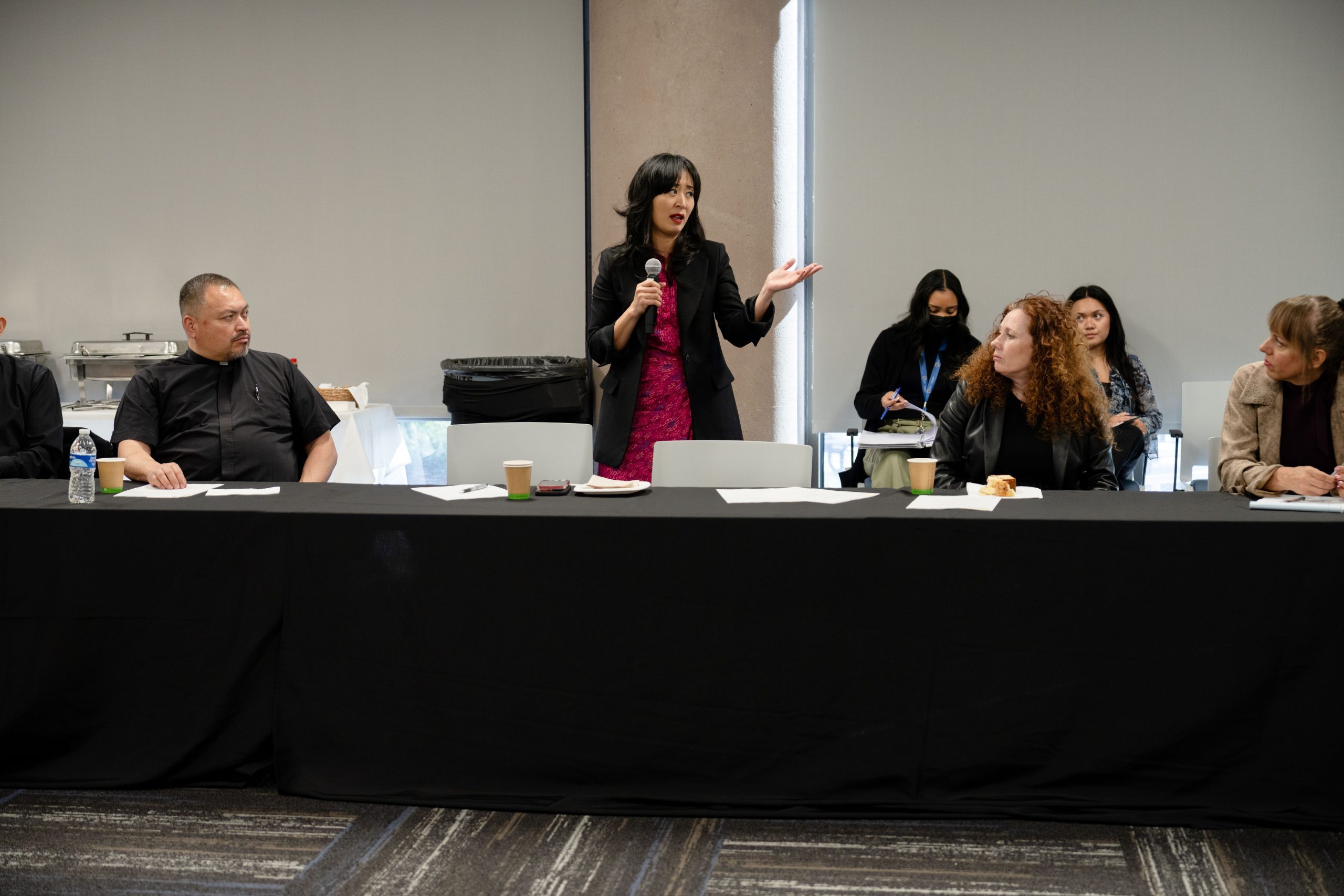 San Bernardino Mayor Helen Tran stands from her seat to speak to attendees at the homelessness roundtable.