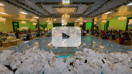 Clip from the video showing the dance hall overlaid with a “play” button.