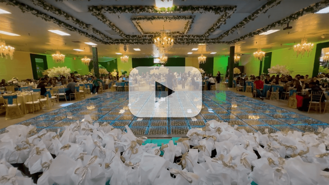 Clip from the video showing the dance hall overlaid with a “play” button.