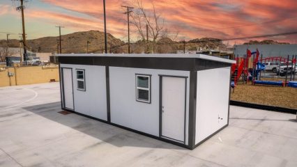 An image of a tiny home near a playground.