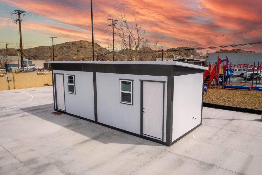 An image of a tiny home near a playground.