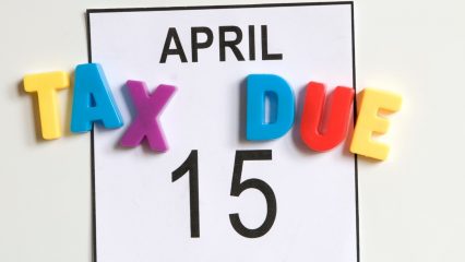 Calendar page with colorful letters spelling TAX DUE over date. Text reads: APRIL TAX DUE 15.