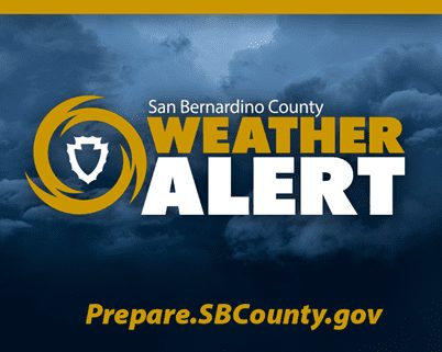 San Bernardino County Weather Alert with county shield in gold hurricane symbol on stormy cloud background. Text: Prepare.SBCounty.gov.