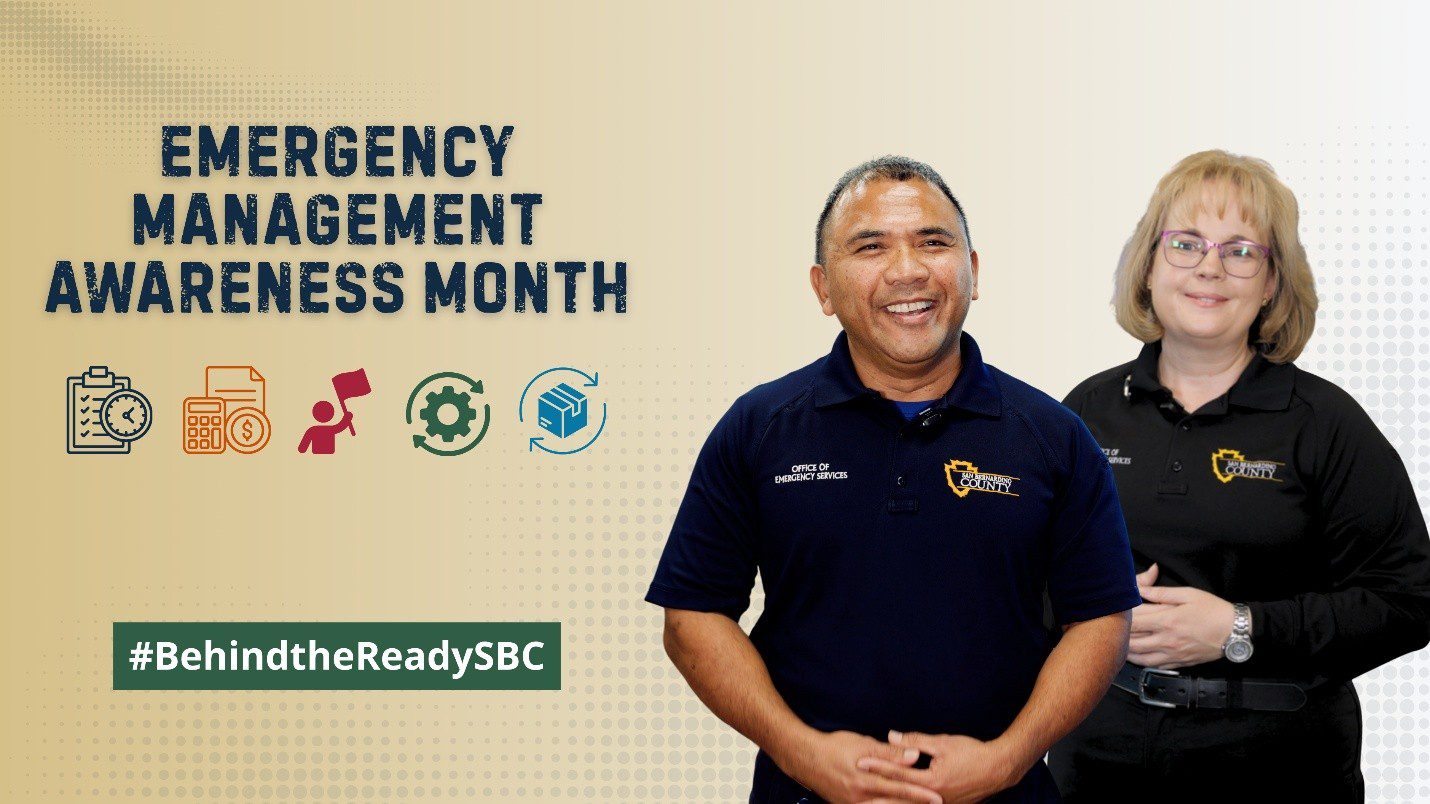 Two County employees smile beside text reading “Emergency Management Awareness Month” and #BehindtheReadySBC.