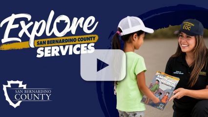 “Explore San Bernardino County Services” and “San Bernardino County” with an Office of Emergency Services employee giving a child a preparedness comic.