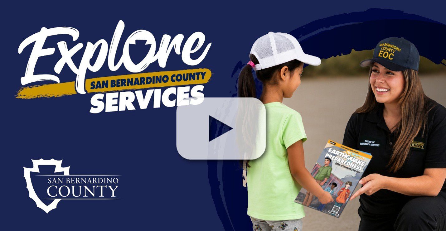 “Explore San Bernardino County Services” and “San Bernardino County” with an Office of Emergency Services employee giving a child a preparedness comic.