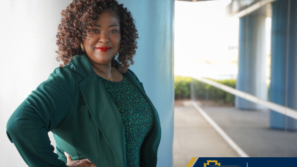A woman standing outside near a pillar and window, with shrubs in the background and the Child Support Services logo in a blue and gold box.
