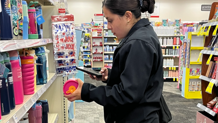 Officer checks the price of a water bottle during a county Agriculture/Weights & Measures Price Scanner Program inspection at a local retail store.