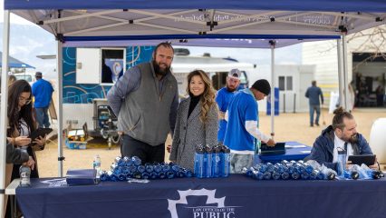 Public Defender staff at outreach booth with water bottles under a San Bernardino County tent in Lucerne Valley.